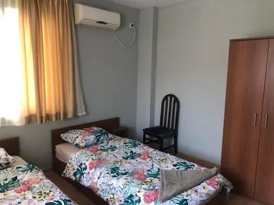 a small bedroom with a bed and a dresser at Nesebar New Town Apartment in Nesebar