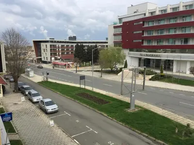 a city street with cars parked in a parking lot at Nesebar New Town Apartment in Nesebar