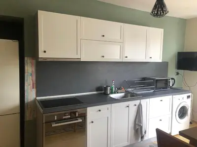 a kitchen with white cabinets and a sink at Nesebar New Town Apartment in Nesebar