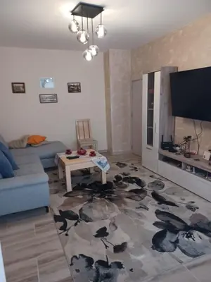 a living room with a couch and a table at Comfort apartment near the beach in Varna City