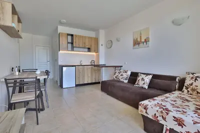 a living room with a couch and a table and a kitchen at Apartament Casa del Sol no 115 in Sunny Beach