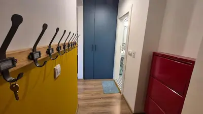 a row of hoses in a hallway with a door at Cozy Corner in Varna - Free Parking in Varna City