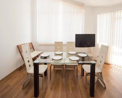 a dining room with a glass table and chairs at 