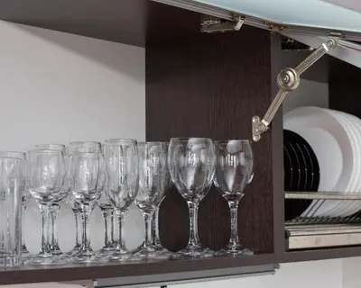 a row of wine glasses sitting on a shelf at 