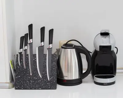 a group of kitchen utensils next to a coffee maker at 