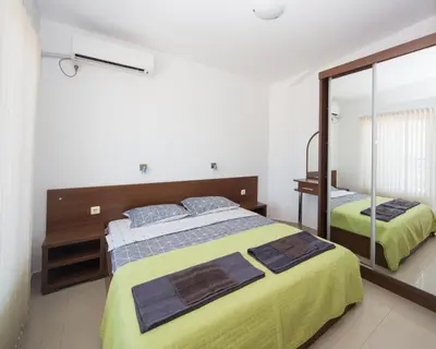 a bedroom with a large bed and a mirror at 
