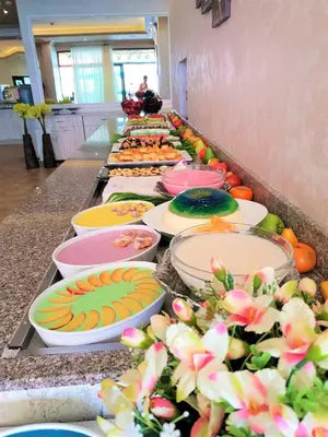 a buffet line of plates of food on a counter at Grenada Complex All Inclusive in Sunny Beach