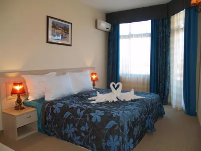 a bedroom with a bed with a stuffed animal on it at Grenada Complex All Inclusive in Sunny Beach