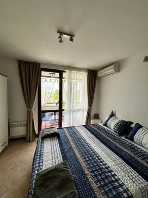 a large bed in a bedroom with a window at Oasis Premium Studio in Lozenets