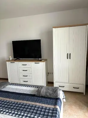 a bedroom with a bed and a flat screen tv at Oasis Premium Studio in Lozenets