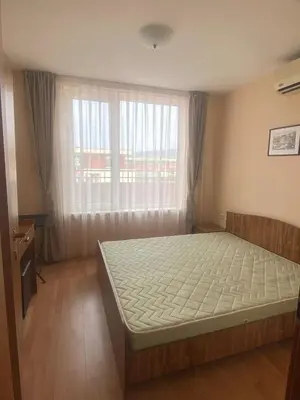 a bedroom with a bed in front of a window at 2 Bed Suite with Pool Views in Sunny Beach