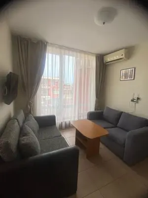 a living room with two couches and a table at 2 Bed Suite with Pool Views in Sunny Beach