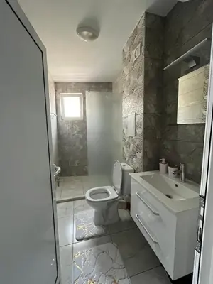 a bathroom with a toilet and a sink at Апартамент Габи 1 in Burgas City