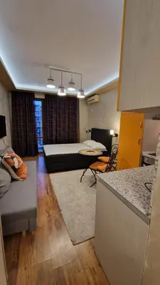 a living room with a couch and a bed at MitProt Panorama Bay 2 luks Studio 158 in Sveti Vlas
