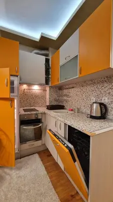 a kitchen with yellow cabinets and a stove top oven at MitProt Panorama Bay 2 luks Studio 158 in Sveti Vlas