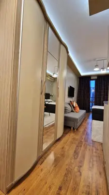 a living room with a couch and a mirror at MitProt Panorama Bay 2 luks Studio 158 in Sveti Vlas