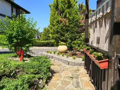 a garden with a stone path and plants at Stela Apartment in Santa Marina Holiday in Sozopol