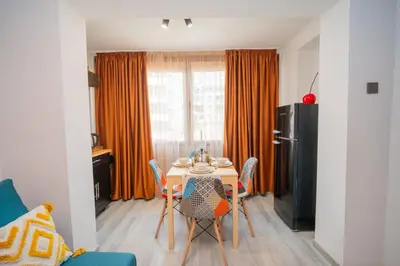 a kitchen with a table and chairs in a room at Бургаски вечери Burgas nights in Burgas City