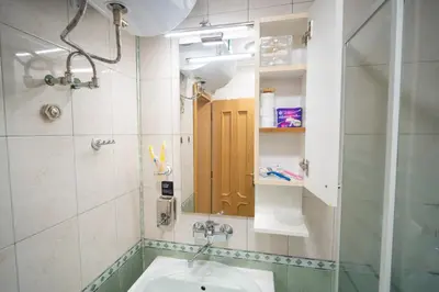 a bathroom with a sink and a mirror at Бургаски вечери Burgas nights in Burgas City