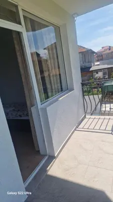 a sliding glass door on a balcony of a building at Къща за гости Ravda in Ravda