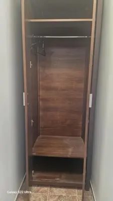a cupboard with a wooden door in a room at Къща за гости Ravda in Ravda
