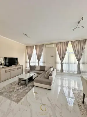 a large white living room with a couch and a tv at Villa Roma Gs' Apartment in Nesebar