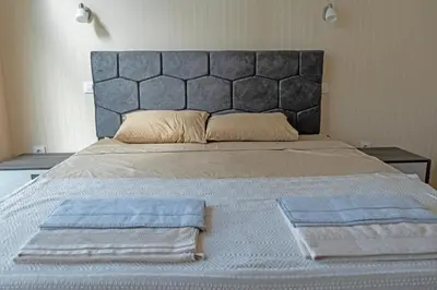 a bedroom with a large bed with two towels on it at Villa Roma Gs' Apartment in Nesebar
