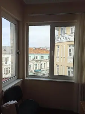a window in a room with a view of a building at Апартамента на центъра на Варна до фонтаните in Varna City