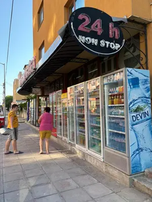a man and a woman standing in front of a store at Cozy studio in Sunny beach in Sunny Beach