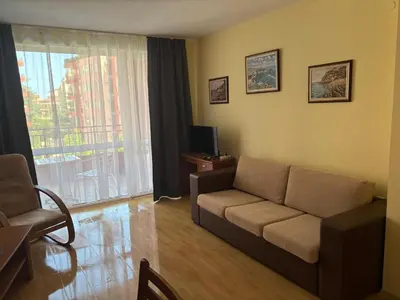 a living room with a couch and a television at Amartmán přímo u moře - Elenite in Sveti Vlas