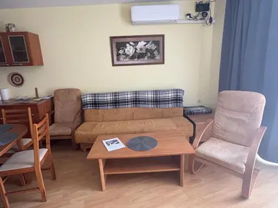 a living room with a couch and a table and chairs at Amartmán přímo u moře - Elenite in Sveti Vlas