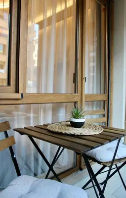 a table with a potted plant on top of it at Cozy by the Sea in Burgas City