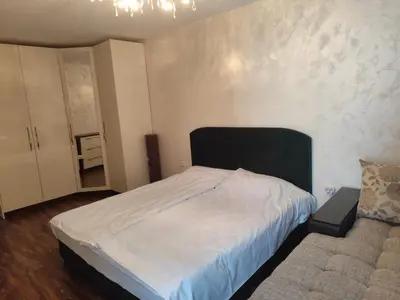 a bedroom with a white bed and a couch at Villa Alva in Pomorie
