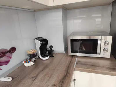 a microwave oven sitting on top of a wooden floor at Villa Alva in Pomorie