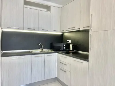 a white kitchen with a sink and a microwave at Millennium 2 - Private apartment - BSR in Sveti Vlas