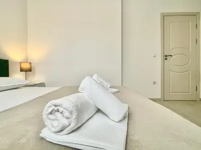 a hotel room with a bed with towels on it at Millennium 2 - Private apartment - BSR in Sveti Vlas