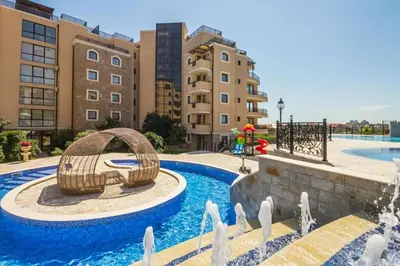 a swimming pool with a water slide in front of buildings at Millennium 2 - Private apartment - BSR in Sveti Vlas