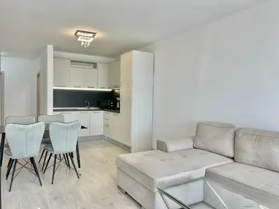 a living room with a couch and a table and a kitchen at Millennium 2 - Private apartment - BSR in Sveti Vlas