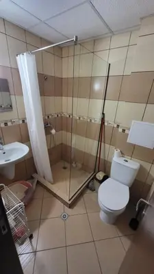 a bathroom with a toilet and a shower and a sink at Apartamenty na Zielonych Wzgórzach in Sunny Beach