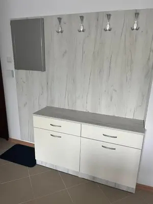 a white cabinet with a television on top of it at Apartamenty na Zielonych Wzgórzach in Sunny Beach
