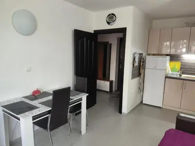 a small kitchen with a table and a refrigerator at 2 Zimmer Wohnung in Sunny Beach in Sunny Beach