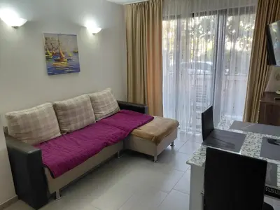 a bedroom with a bed with a purple blanket at 2 Zimmer Wohnung in Sunny Beach in Sunny Beach