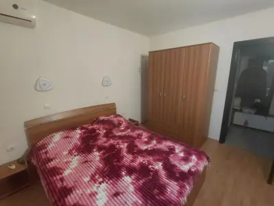 a bedroom with a bed with a red blanket at 2 Zimmer Wohnung in Sunny Beach in Sunny Beach