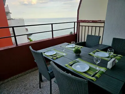 a table on a balcony with a view of the ocean at The Sea Balcony - 1BD Apartment by Flat Mаnager in Burgas City