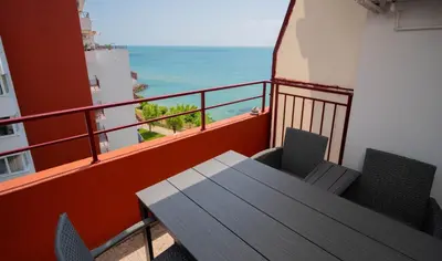 a balcony with a table and chairs and the ocean at The Sea Balcony - 1BD Apartment by Flat Mаnager in Burgas City