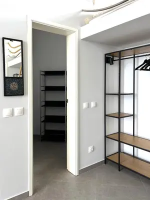 a room with white walls and a door with shelves at Slow Living House in Lozenets
