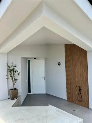 a room with a white wall and a door at Slow Living House in Lozenets