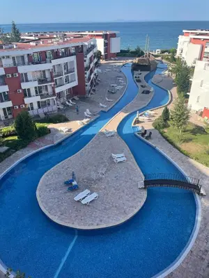 a swimming pool with blue water in a resort at Amartmán přímo u moře - Elenite až 5 osob in Sveti Vlas