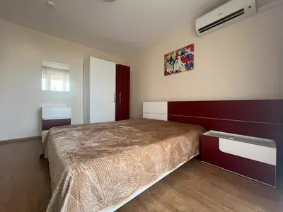 a bedroom with a bed and a red and white wall at PREMIER HOUSE BEACH Hotel in Sveti Vlas
