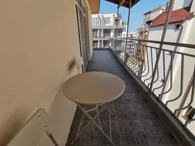 a table on the balcony of a building at Emona 5 floor 4 in Burgas City